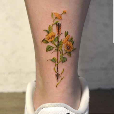 Sunflowers and arrows tattoo Arrow And Sunflower Tattoo, Arrow Flower Tattoo, Sunflower Arrow Tattoo, Flower Arrow Tattoo, Honey Tattoos, Sunflower Foot Tattoos, Wildflower Tattoos, Arrows Tattoo, Violet Flower Tattoos