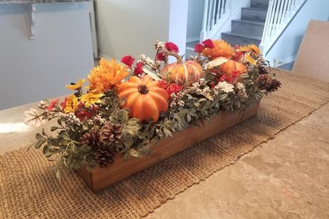 "This floral planter box centerpiece will add just the right fall feeling for your dining room table! Along with this beautiful greenery are festive pumpkins, pine cones, orange mums, yellow sunflowers and picks!  Choose your own planter box size! Choose your own stain color! Choose options at checkout. Item shown: 23\", barnwood stain Planter box shown measures 23\" L x 5\" W x 3\" H (9 1/2\" H with floral)" Living Room Centerpiece Ideas, Dining Room Table Fall Decor Ideas, Farmhouse Centerpiece Table, Fall Dining Room Table Decor, Planter Box Centerpiece, Thanksgiving Decorations Outdoor, Fall Dining Room Table, Fall Floral Centerpieces, Box Centerpiece