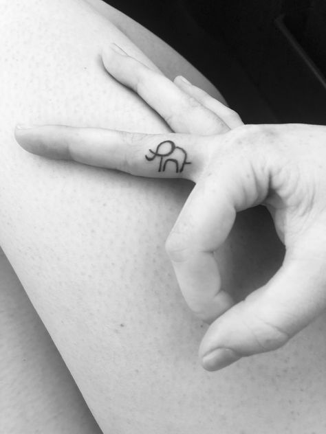 Simple outlined elephant tattoo on finger Finger Elephant Tattoo, Elephant Tattoos Finger, Elephant Stick And Poke, Micro Elephant Tattoo, Tiny Elephant Tattoo Simple, Mini Tattoos Elephant, Minimal Elephant Tattoo, Elephant Outline Tattoo, Elephant Finger Tattoo