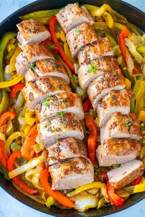 Pork tenderloin is one of our favorite cuts of meat. It’s lean and, just as the name states, very tender. Since we love it so much, we’ve shared our no-fail method for cooking juicy, fork-tender pork tenderloins before. This recipe uses the same process but adds even more flavor with sauteed peppers, onions and garlic. Pork Tenderloin With Peppers And Onions, Pork Tenderloin Meals Dinners, Pork With Peppers And Onions, Side Dishes For Pork Tenderloin, Side Dishes For Pork, Juicy Pork Tenderloin, Pork Tenderloins, Sauteed Onions, Tenderloin Recipe