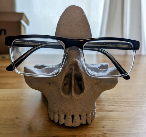 About this item This 3D skull shaped eyeglass/sunglass holder will add a bit of terror to your area with its realistic appearance. Its quirky shape will add eclectic decor to your life. Eyeglass holder stands are handmade with PLA material, which has strong stability, and high wear resistance, safe and neat. The glasses stand is very realistic and a great way to store your glasses when you want to take off your eyeglasses/sunglasses and avoid the lens getting scratched or crushed. Suitable for s Air Dry Clay Glasses Holder, Glasses Holder Clay, Clay Glasses Holder, Eyeglasses Holder Stand, Glasses Organizer, Eyeglass Holder Stand, 3d Skeleton, Home Office Desk Decor, Stud Earrings Holder