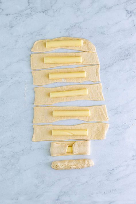 Pizza dough cut up with sticks of mozzarella cheese on each piece - the bottom piece is starting to be rolled up in the dough. Bosco Sticks, Using Pizza Dough, Cafeteria Pizza, School Pizza, Pizza Sticks, Mozzarella Cheese Sticks, Cheese Butter, Country Cook, The Country Cook