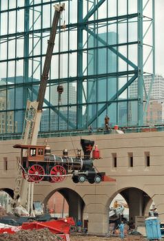 Construction workers lift a replica of a 19th century locomotive onto tracks that run alongside the moveable roof at the Houston Astro's new downtown baseball stadium called Enron Field in Houston, Saturday March 18, 2000. No longer Enron Field, it is now known as Minute Maid Park. The name was changed after the Enron scandal. (AP Photo/Michael Stravato) Enron Scandal, Houston Astros Baseball, Minute Maid Park, Astros Baseball, Construction Workers, Minute Maid, Baseball Stadium, New Building, Construction Worker