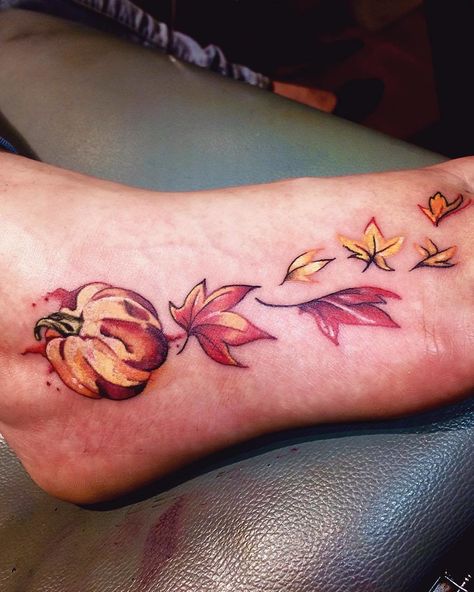 CafeMom.com : Pumpkin & Leaves Foot Fall Tattoo : 40 Tattoos for People Who Are Obsessed With Fall -- This foot tattoo has a season-appropriate color scheme. The red, orange, and yellow inks all complement each other well. The pumpkin is the focal point, but the blowing leaves add a cool effect. Fall Tattoos, Fall Leaves Tattoo, Fall Tattoo, Tattoo Chart, Winter Tattoo, Tattoo Pics, Pumpkin Tattoo, Mystical Tattoos, Autumn Tattoo