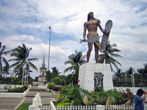 Statue of Lapu Lapu on Mactan Island, Cebu, Philippines. Lapu Lapu was a chieftain on Mactan Island and the commander of the Filipino native forces which killed Ferdinand Magellan at the Battle of Mactan in 1521. Battle Of Mactan, Mactan Island, Philippines Cebu, Ferdinand Magellan, Visit Philippines, Philippines Travel Guide, 10 Interesting Facts, Cebu City, Today In History