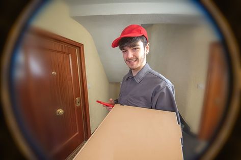 Fast food delivery man with pizza box in his hands delivering the order, dressed in uniform and smiling, customer looking through the peephole Fast Food Delivery, Pizza Delivery Boy, Pizza Delivery Man, Delivery Guy, Pizza Boy, Pizza Delivery Guy, Delivery Pictures, Food Order, Order Pizza