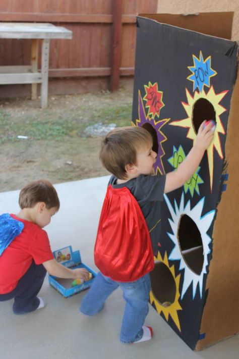 Homemade bean bag toss game for superhero themed party Superhero Carnival Party, Super Hero Carnival Games, Halloween Bean Bag Toss, Summer Camp Superhero Theme, Superhero Bean Bag Toss, Homemade Beans, Bean Bag Toss Game, Superhero Theme Party, Toss Game