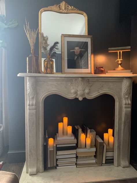 Faux Fireplace Fairy Lights, Mantle And Fireplace Decor, Books Inside Fireplace, Mock Fireplace Mantle, Non Working Fireplace Makeover, Candlesticks In Fireplace, Faux Fireplace With Candles Inside, Fireplace Mantle No Fireplace, Faux Mantel Decorating Ideas