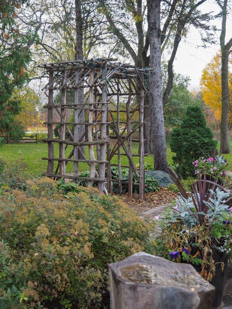 How to Build Garden Obelisk Trellis with Branches and Twigs    How to Build Garden Obelisk Trellis with Branches and Twigs - The vertical element in the garden adds great interest and a pleasing feature to a gardens bed.    How to Build Garden Obelisk Trellis with Branches and Twigs - The vertical element in the garden adds great interest and a pleasing feature to a gardens bed.    How to Build Garden Obelisk Trellis with Branches and Twigs - Enjoy this step by step video on how to bu… Diy Trellis With Branches, Cedar Branch Projects, Trellis Made From Branches, Twig Arbor Diy Branches, Tree Branch Arbor Diy, Branch Obelisk, Twig Garden Structures, Trellis From Branches, Grape Arbour