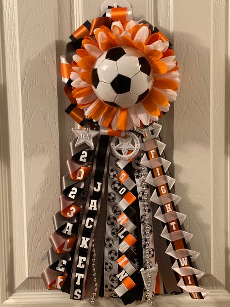 Soccer mum- orange, black, white, gray and silver. #homecoming #texas #homecomingmum #pewee #soccer #highschool Soccer Mums Homecoming, Orange And Black Homecoming Mums, How To Make Hoco Mum Braids, Garters Homecoming, Soccer Mum, Hoco Mum Chains, Homecoming Mum Heart Chain, Military Braid Homecoming Mums, Homecoming Garter