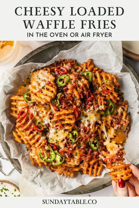 These cheesy loaded waffle fries with bacon, jalapeños, and chives are the perfect party food! Made with frozen fries, this appetizer is easy to whip up in the oven or air fryer. You can even use sweet potato fries! This is one of my favorite finger foods for a party, game day, movie night or get-together with friends. You can also top the fries with chicken, ground beef, pulled pork, or veggies for a vegetarian option. These fries are delicious with all kinds of toppings, sauces, and cold ... Bbq Loaded Fries, Loaded Waffle Fries Recipe, Pulled Pork Loaded Fries, Waffle Wings, Fries With Chicken, Loaded Waffle Fries, Sweet Potato Waffle Fries, Waffle Fries Recipe, Holiday Bites