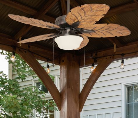 The Harbor Breeze Waveport ceiling fan features palm leaf shaped blades and frosted glass. Crafted from quality materials, this fan is damp rated and durable so you can enjoy this fan on an enclosed patio or porch year round. Features an energy efficient LED light kit for superior performance and is virtually maintenance-free. Harbor Breeze Waveport 52-in Aged Bronze with Brown Blades LED Indoor/Outdoor Downrod or Flush Mount Ceiling Fan with Light (5-Blade) | WK52NWZ5L Beach Ceiling Fan, Coastal Ceiling Fans With Lights, Porch Ceiling Fans, Boho Ceiling Fan, Leaf Ceiling Fan, Coastal Ceiling Fan, Tropical Ceiling Fans, Bunk Rooms, Enclosed Patio