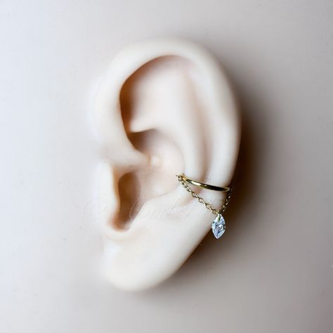 * Size in the main photo is 10mm conch Marquise CZ gold.  Available in the following finish.  Implant grade titanium in silver or gold.  Gauge: 16 or 18g Diameter: 6mm, 8mm, 10mm, 12mm Sold as single. I ship worldwide. Conch Earring Jewelry Silver, Hanging Helix Piercing, Floating Helix Piercing, Ear Piercings Conch, Hoops With Charms, Piercing Conch, Conch Hoop, Helix Jewelry, Runway Jewelry