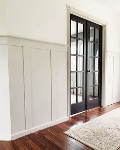 Greige Molding White Walls, Beige Trim Black Door, Stained Hollow Core Door, Entranceway Paint Colors, Beachy Neutral Aesthetic, Wainscot Color Ideas, Neutral Paint Ideas For Living Room, Wall Petition Ideas, Neutral Wall Paint Living Room