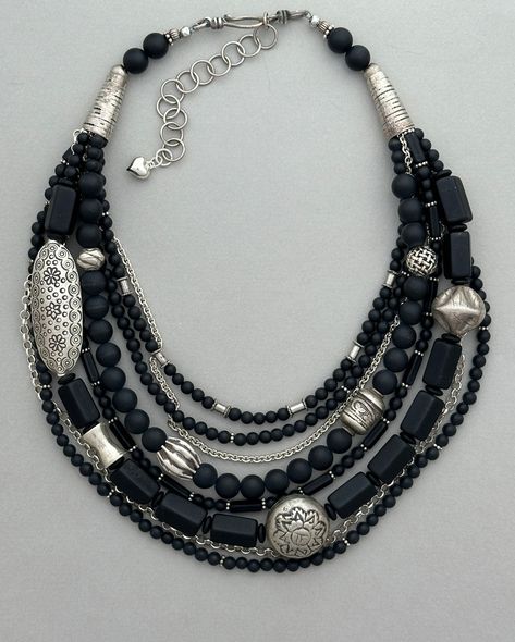 One-of-a-kind multi-strand statement necklace. Handcrafted in Scottsdale, Arizona. Beads: Matte black onyx, vintage glass, antique and sterling silver. Dimensions: approximately 21" with 2.5" extender Make a Statement with this elegant necklace. Free Shipping Refund Policy