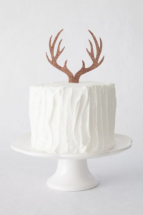 This antler cake topper from The Sprinkle Sisters is made with bronze glitter card stock. It will make a great centre piece for your Woodland Themed party or baby shower.  The antler measures approximately 6″ wide and is double sided.  For reference, the cake pictured is an 8″ double layer cake.  For custom orders, please contact the shop. Baby Boy Shower Cakes, Deer Party, Baby Boy Cake Topper, Woodland Party Theme, Deer Baby Showers, Baby Shower Cakes For Boys, Trendy Baby Shower Ideas, Baby Boy Cakes, Baby Shower Woodland Theme