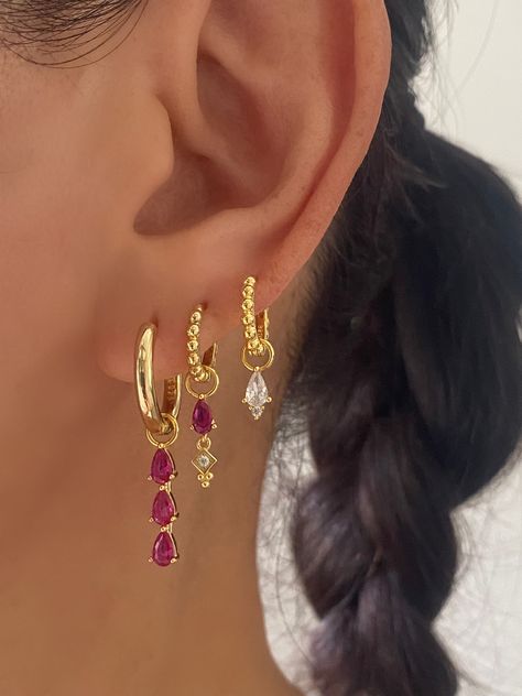 This gorgeous set comes with • 1 Pair of 3 Teardrop Pink charm with 17mm Hoop Material: 18k Gold plated on 925 sterling silver, AAAAA Cubic Zirconia • 1 Pair of Pink Teardrop charm with 15mm Princess Hoop Material: 18k Gold plated on 925 sterling silver, Cubic Zirconia • 1 Pair of Single Clear charm with 12mm Princess Hoop Material: 18k Gold plated on 925 sterling silver, AAAAA Cubic Zirconia • 1 Anett Gift Box HypoallergenicNickel free and Lead free 3 Earring Set, Colorful Gold Earrings, Pink Earring Stack, Cool Gold Earrings, Pink Earrings Aesthetic, Earring Stack Ideas, Jewelry Colourful, Earrings Stack, Earring Stacks