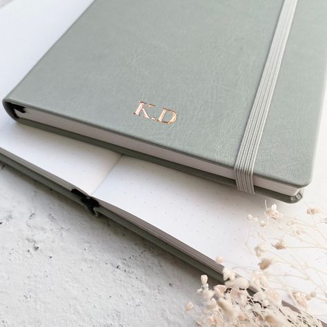 Our grey dot grid notebook with white dotted paper (also available with plain or lined paper) is perfect for bullet journaling, notes, line drawings, to-do-lists and more. A5 in size and in soft vegan leather, they make a sophisticated gift for a new job, promotion, birthday, anniversary or special occasion. Personalise with initials, a monogram or short name. #journal #notebook #planner #personalised #stationery #notepad Notebook Photography, Notebook Personalised, Embossed Notebook, Personalised Stationery, Monogram Notebook, Dotted Paper, Personalised Keyrings, Foil Printing, Job Promotion