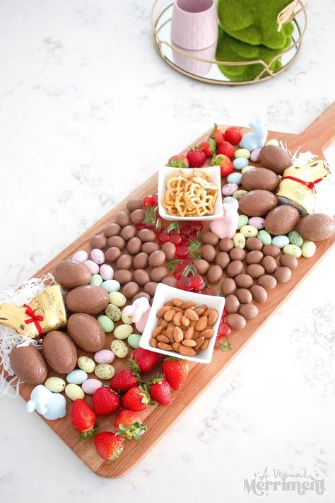 Need to whip up an easy treat board this Easter? With a few supplies it doesn't need to be difficult. I'll show you the quick Easter charcuterie board I made for the family on Easter weekend, head over to A Visual Merriment for the scoop | Easter grazing board, spring dessert board with easter eggs, candy and treats. Easter Charcuterie Board Dessert, Desert Charcuterie Board Easter, Easter Sweet Charcuterie Board, Easter Egg Shaped Charcuterie Board, Easter Bunny Cheese Board, Easter Snack Board Kids, Easter Grazing Board, Grazing Platter Ideas, Easter Charcuterie Board