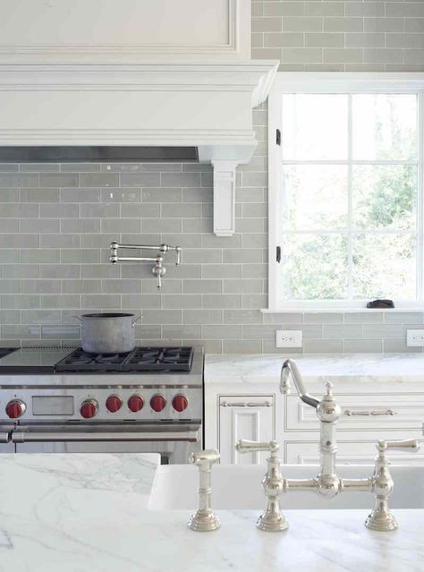 gray glass kitchen backsplash with carrera marble counters in a pretty traditional white kitchen. Nickel faucet and wolf range Gray Subway Tile Backsplash, Glass Kitchen Backsplash, White Kitchen Traditional, Grey Subway Tiles, White Kitchen Backsplash, Grey Backsplash, Kabinet Dapur, Herringbone Backsplash, Kitchen Backsplash Designs