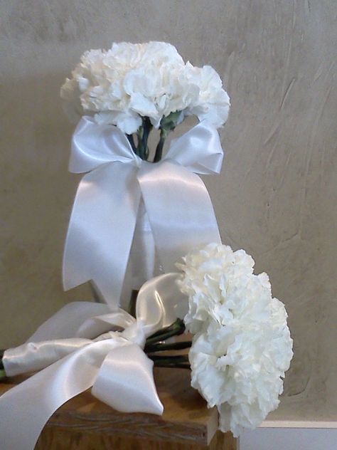 Not sure what color would go good with those awesome bridesmaids dresses you picked out? Go with something simple. These all white carnation bouquets are perfect and the ribbon wrap and bow make them super cute coming down the aisle! White Carnation Bouquet, Carnation Wedding, Carnation Bouquet, Ribbon Wrap, White Ribbon, Bridesmaid Bouquet, How To Make Bows, Flower Shop, White Wedding