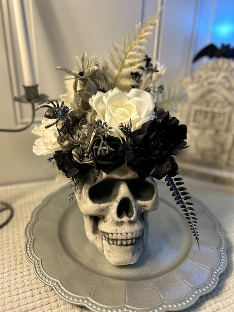 Black and white Halloween, skull centerpiece, Halloween decor, Halloween wedding Beautiful black, white and silver Halloween decor. Skull sits on a silver charger with a beautiful design etched on it. Also comes with a silver gunmetal colored candelabra that holds 3 candles. This piece is separated so you can use elements all year long. Gothic Party Centerpieces, Hallowedding Centerpieces, Silver Candelabra Centerpiece, Elegant Halloween Wedding Centerpieces, Spooky Wedding Centerpieces, Halloween Wedding Ideas On A Budget, Skeleton Centerpieces, Halloween Dining Room Decor, Diy Candelabra Centerpiece