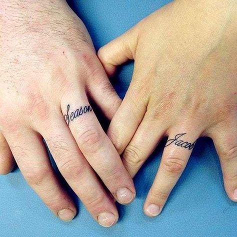 Looking for an awesome ring tattoo? You've come to the right place. This list rounds up some incredible ring tattoo designs, from simple black ink patterns to colorful, intricate works of body art. Some ring tattoos even span multiple fingers. All of these ring tattoos are a reflection of the... Tatoo Ring, Engagement Tattoos, Wedding Ring Finger Tattoos, Married Couple Tattoos, Marriage Tattoos, Ring Tattoo Designs, Wedding Band Tattoo, Tattoo Band, J Tattoo