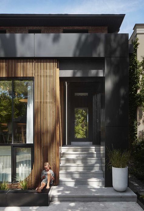 A partial wood slat facade softens the exterior of this modern house, while steps lead to the entryway and front door, which also includes LED lighting. House Exterior Cladding, Renovation Facade, Cladding Exterior, Walker House, Wooden Cladding, External Cladding, House Cladding, Modern Renovation, House Facade