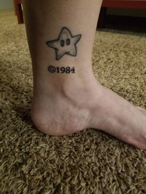 Newest tattoo on 2-12-2018.  Had copyright 1984 (the year I was born) added to my dancing Mario star. Mario Galaxy Star, Mario Star Tattoo, 1984 Tattoo, Mario Tattoo, Mario Star, Number Tattoos, Super Mario Galaxy, Star Tattoo, Star Tattoos