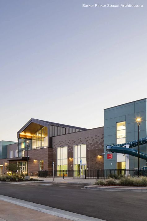 Located in Northglenn, Colorado, Northglenn Recreation Center offers the community a performing arts theater, swimming pools, senior center, and more for them to use. Max Compact Exterior HPL panels from Fundermax were combined with other woodgrain and plain color panels, giving the facade this sense of modernity through the natural material decor AF Patina. For more project images and information, visit: https://fundermax.us/projects/northglenn-recreation-center/ Recreation Center Design, Performing Arts Theater, Leisure Pools, Senior Center, Sims House Design, Recreation Centers, Theatre Arts, Plain Color, Sims House