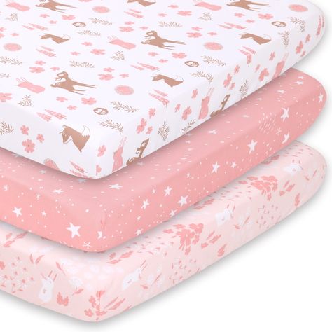 The whimsical woodland floral playard sheet set from The Peanutshell includes 3 unique allover prints in feminine shades of pink, tan and white. A sweet character toss with deer, owls, hedgehogs, trees, and flowers; tossed celestial stars; and a bunny floral meadow print make up this well-curated trio. The all-around elastic design ensures a safe and snug fit that's compatible with most standard playard mattresses. The fade-resistant material is quick-drying and machine washable, providing excellent quality and easy care at a great value.  This set includes three fitted multipurpose sheets designed to fit a playard, mini crib, or pack n play with 3 to 5 inch deep mattresses and between 24x38 and 27x39 dimensions. All-around elastic ensures a safe and snug fit. The fabrics in our fitted Pla Pack N Play Mattress, Pack And Play Sheets, Pink Woodland, Woodland Floral, Floral Meadow, Celestial Stars, Trees And Flowers, Whimsical Woodland, Pink Sheets