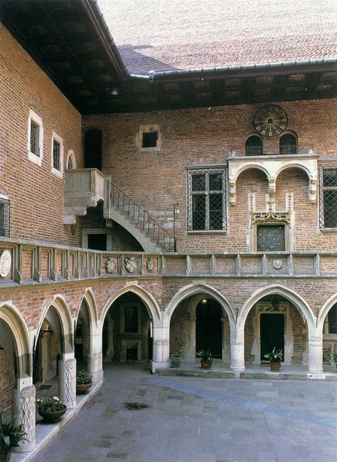 The Collegium Maius in Cracow is one of the few medieval university buildings in Europe. It was built by Johann the Mason in 1492-97. The wings are grouped around a courtyard, the main features of which are an arcade placed forward of the wall to accommodate the upper-level walkway, over which looms a roof over-hang of the same width as the walkway. Medieval University, Medieval Courtyard, Medieval England, Scene Art, 11th Century, The Wings, 14th Century, 15th Century, Eastern Europe