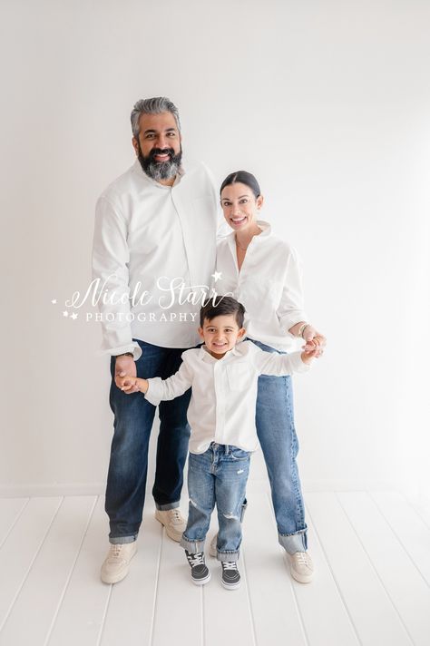 parents pose with four year old son wearing matching jeans and white button down shirt during simple studio family portraits with Saratoga Springs NY family photographer Nicole Starr Photography Family Of 3 Poses Toddlers, Family Photoshoot White Background, Family Of 3 Photoshoot Older Child, Photoshoot Family Of 3, Background Family, Studio Family Portraits, Family Portrait Outfits, Fam Pics, Family Photoshoot Poses