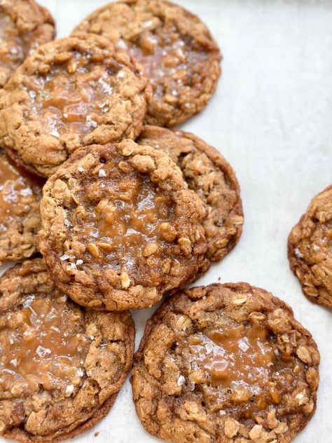 a bunch of caramel oatmeal cookies stacked on top of eachother. Salted Caramel Oatmeal, Carmel Oatmeal Cookie, Salted Caramel Oatmeal Cookies, Toffee Oatmeal Cookies, Oatmeal Caramel Cookies, Oatmeal Cookie Cake, Salted Toffee Cookies, Caramel Oatmeal Cookies, Oatmeal Butterscotch Chip Cookies