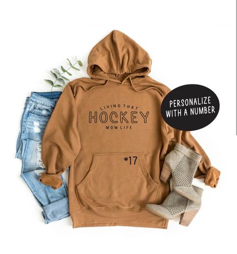 Loving that hockey mom life  printed in white or black (choose from the drop down arrow) on a super soft and cozy brown sweatshirt, Please refer to the size chart to make sure you grab the correct size. These are unisex   Don't forget if your in GP use the code LOCAL to waive shipping and pickup - please add your cell so i can message when ready Hockey Shirts Funny, Hockey Mom Sweatshirt Hoodie, National Hockey Mom Day, Cricut Hockey Shirts, Hockey Mom Gifts Diy, Hockey Hoodie Ideas, Hockey Mom Sweater, Hockey Mom Hoodie, Hockey Tshirt Ideas