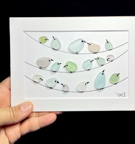 Sea Glass Art by Cristina Lugo on Instagram: "My faithful friends since I started this creative journey, the birds on the wire. My favorite part is  that every one has a personal interpretation of the scene. This time, my friends are framed inside a grey 5x7 shadow box and, they are available. If you want more information about them, just message me privately. #birdsonawire #pajarosenelalambre #birds #pajaritos #birdneighborhood #lavecindad #seaglass #vidriodemar #cristaldeplaya #madeinpuertorico #puertoricoseaglass #hechoenpuertorico #seaglasspuertorico #beachhousedecor #beachstyle #casadeplaya #cuteart" Sea Glass Bird Art, Seaglass Art Ideas, Seaglass Birds, Seaglass Ideas, Sea Glass Art Projects, Glass Art Projects, Sea Glass Crafts, Creative Craft, Beach Crafts