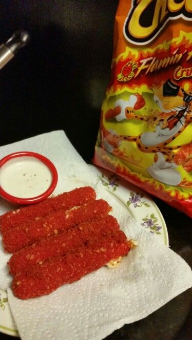 Hot cheetos cheese sticks! Super easy A package of string cheese, 2 eggs, crushed hot cheetos, and ranch. All need to do is put the string cheese in the egg wash, then roll in the hot cheetos dust, then back in the egg wash and dust it again. Then I deep fried them for 3 minutes or until crispy. Enjoy Hot Cheeto Food Ideas, Hot Cheetos Recipes Ideas, Snacks With Hot Cheetos, Black Hot Cheetos, Extra Hot Cheetos, Deep Fried Food, Snack Craving, Junk Food Snacks, Food Combining