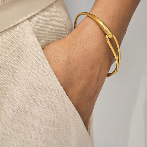 Our Infinity Gold Cuff Bangle is the perfect minimalist bangle with a glossy finish. This chic bangle is great for wearing alone or stacked with other bangles. Please note this bangle is not adjustable. This item is made from 316L stainless steel which is of the highest quality and waterproof as well as nickel free, lead free and cadmium free. We make our jewellery in small batches to reduce wastage. Our jewellery is designed with the modern Woman in mind, elegant, unique pieces with a classic t Modern Gold Jewelry Unique Designs, Gold Bracelet For Women Classy, Gold Cuff Bangle, Minimalist Bangle, Modern Bangle, Stacking Bangles, Gold Bangles For Women, Diamond Pendent, Gold Cuff Bracelet