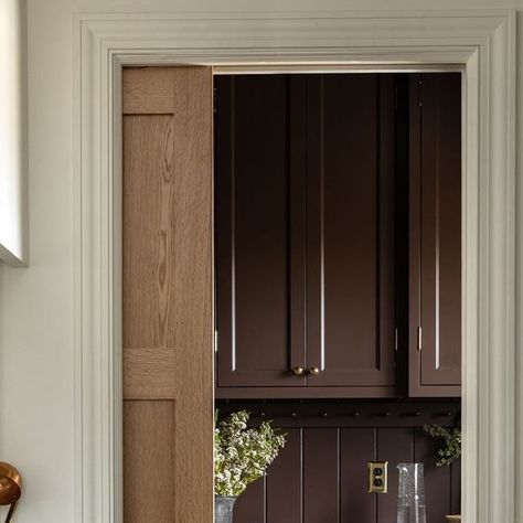 Oho Interiors | Melissa Oholendt on Instagram: "Pro tip: Always peek behind a pocket door. In this case, it reveals what might be our favorite pantry to date, coated Farrow & Ball’s Cola. The soapstone counters along with the v-groove backsplash and colordrenching help create a cozy, cocoon-like room that balances out the more neutral kitchen.

Photography by @judithmarilyn_
Styling by @cate.ragan.styling
Design by @oho_interiors" Soapstone Counters, Ogee Edge, Neutral Kitchen, Cabinet Paint Colors, Kitchen Pantry Design, Cabinetry Design, Pantry Design, Interior Photography, Utility Room