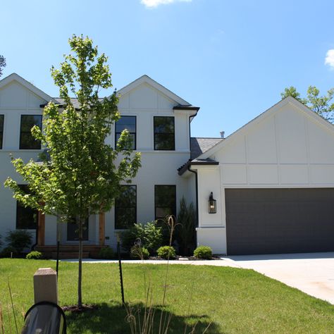 Arctic White James Hardie panel siding was used to complete the front of this beautiful modern project. dutchlap vinyl sidng was used on the sides and rear to complament the panel. Hardie Panel Siding, Hardie Arctic White, White Board And Batten, James Hardie Siding, Cheap House, White Siding, Hardie Siding, Andersen Windows, James Hardie