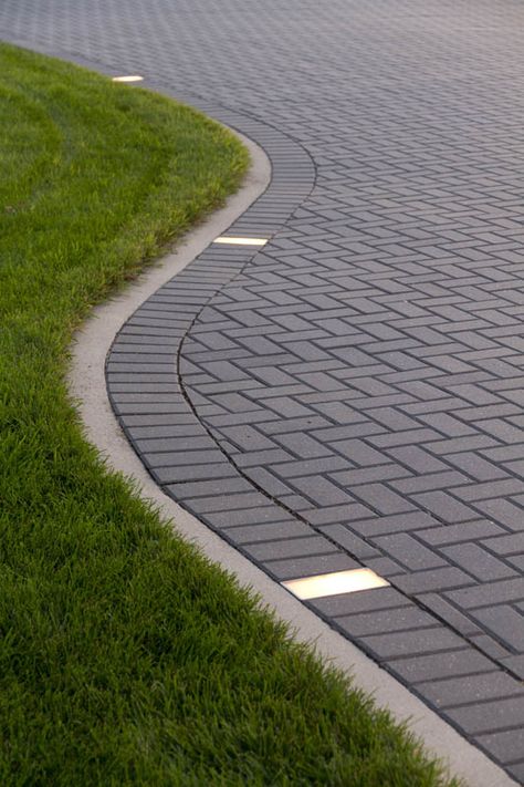 The addition of paver lights create a great accent to this Holland driveway. Driveways With Pavers, Lighted Driveway Ideas, Modern Pavers Driveway, Paver Driveway Designs, Pavers Lighting, Driveway Paving Design, Lighted Driveway, Driveway Flooring, Driveway Lighting Ideas