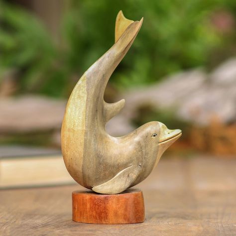 Balis' Eka presents this hand-carved dolphin crafted from hibiscus wood with a suar wood base. By leaving the sculpture unfinished the colors and wood grains are able to shine through for a contrasting but complementary look. Dolphin Craft, Wood Sculpture Art, Shell Sculpture, Seahorse Art, March Birthday Gifts, Baroque Art, Wood Carving Designs, Christmas Wood Crafts, Carving Designs