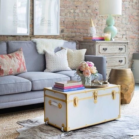 15 Beautiful Ways to Decorate With Trunks - Brit + Co Trunk In Living Room, Living Room With Brick Wall, Brick Wall Living Room, Small Trunk, Unique Living Room Furniture, Wall Decoration Ideas, Contemporary Living Room Furniture, Living Room Styles, Shabby Chic Living