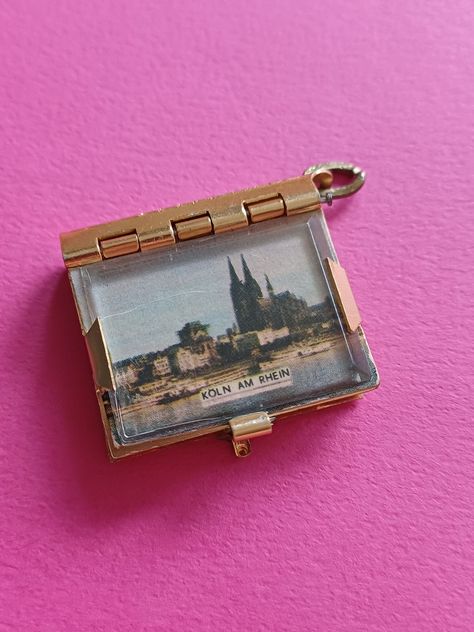 Vintage gold plated book locket pendant charm of Germany, vintage book locket with pictures of famous locations of Rhein Germany. The closure of the book works perfectly. In vintage condition. Size 1.22 inches x 1.12 inches without eyelet. Height 0.33 inches. Single item FREE SHIPPING Just send me a message whenever you have a question. I'm here to help! Shipping is for FREE. When you want insured mail or track and trace, please contact me about the options and costs. Love, Jackie ❤ Book Works, Book Locket, Famous Buildings, Best Perfume, Dream Jewelry, Vintage Book, Cute Jewelry, Vintage Watches, Vintage Gold