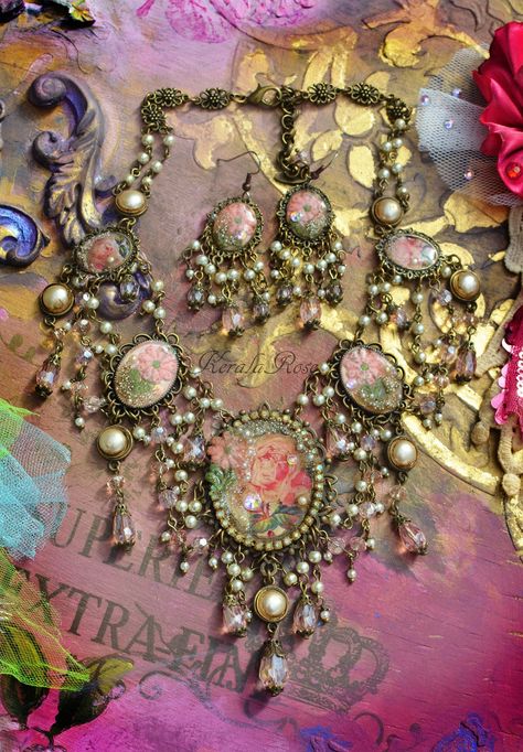 "This beautiful Feminine handmade necklace and earring set is made with Vintage rose images and vintage floral embroidery appliques resin-set into bronze metal frames with draped strands of faceted Pink crystal and cream pearl beads.  Crystal rhinestones and glass pearl dust decorate the pendants for an added texture and sparkle!  The chandelier earrings measure 3\" long x 1\" wide, in your choice of piercing. The back is a lobster clasp and extension chain. Bronze metals. *If you require a larg Vintage Floral Embroidery, Vintage Jewelry Diy, Vintage Jewelry Repurposed, Rose Images, Cameo Jewelry, Jewelry Accessories Ideas, Craft Jewelry, Pearl Cream, Rose Necklace