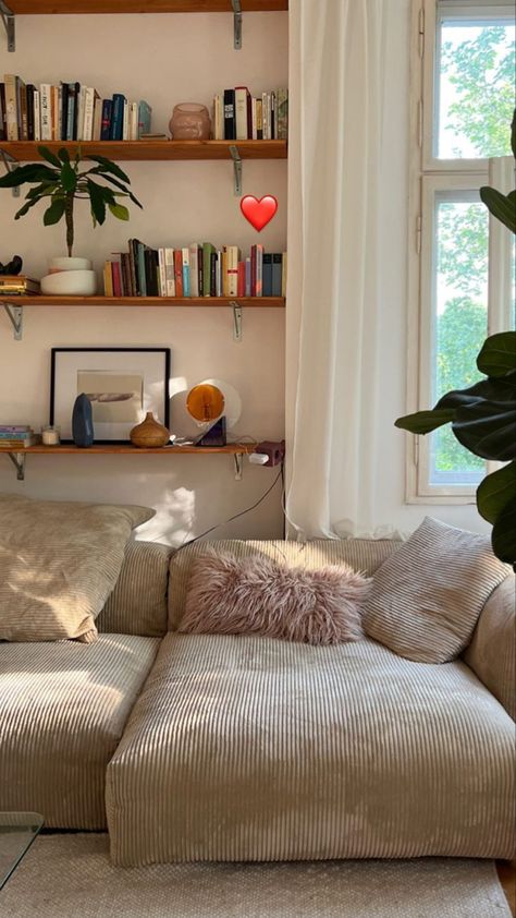 Coed Living Room Decor, Urban Outfitters Home Living Room, Sofa Middle Of Room, Cozy Small Apartment Living Room, Couch Against Window, Extra Living Room Space Ideas, Bookshelf Behind Couch, Sand Couch, Colorful Minimalist Home