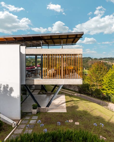 Gallery of TKN House / OTP Arquitetura - 7 Stilts House, Raised Houses, Modern Stilt House, Stilted House, Slope House Design, House On Slope, Slope House, Modern Tropical House, Lake Houses Exterior