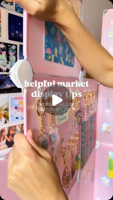 Jazlynn on Instagram: "Here are some tips I learned from my markets this summer 🥰 

✨ Command Hooks for Keychains and Charms ✨
I love command hooks because they hold on my keychains so well! I don’t bother removing them bcuz they don’t fall, so I keep them on my display when I pack up. This way I don’t have to replace my items every new market I attend and I can just pull out the finished pink display board! Saves me a lot of time to not have to put up ALL my keychains again. Although my charms have a much slimmer string and those do fall off so I have to constantly remove and add those 🙈. 

Pretty sure I got this idea from @heluhime! 

✨Add some cute decorations!✨ 
It helps to give your display a bit of your personality and art vibes to attract people! This is mostly personal preference Display Keychains, Keychain Display Ideas, Pink Board, Cute Decorations, Attract People, Keychain Display, Out Of Space, Command Hooks, Market Displays