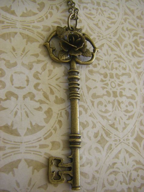 Great accessory featuring a long (3 inch) ornate bronze key charm. I added a beautiful 3D bronze rose for a Victorian touch. The key has a detailed bit and bow and hangs on a lovely brass chain that is 24 inches. If you desire a different length, please let me know. I can adjust it to be shorter or slightly longer. Your key necklace will arrive beautifully packaged, ready for gifting. Key Aesthetic, Victorian Key, Secret Garden Book, Bronze Accessories, Key Charm Necklace, Victorian Accessories, Unique Key, Old Keys, Vintage Key