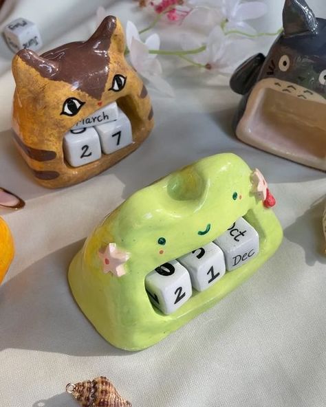 B&P • Clay + Jewel Artist on Instagram: "Upcoming New year demands new calenders 🤍
.
Go pick yours from the website || 
•Froggo 
•Cat Bus
•Calcifer 
•Totoro
.
(Stationery , art , studio ghibli , cozy , indian small biz , memopads , posters , stickers , handmade shop )

#studioghibli #totoro #posters #cozy #aesthetic #cutestationery #stationeryindia #ghibli #ghiblilove #clay #claycharms #fyp #handmade #handpainted #howlsmovingcastle #kikideliveryservice #magnet #foryou #foryoupage #reels #deskbuddy #calendar #ghiblicalendar #perputalcalendar" Studio Ghibli Ceramics, Clay Calendar, Studio Ghibli Clay Art, Ghibli Merch, Studio Ghibli Crafts, Cat Bus, Art Studio Ghibli, Stickers Handmade, Cat Calendar